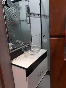 a bathroom with a sink and a mirror at Casa na melhor praia do Recreio dos Bandeirantes in Rio de Janeiro