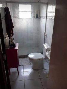 a small bathroom with a toilet and a shower at Casa na melhor praia do Recreio dos Bandeirantes in Rio de Janeiro