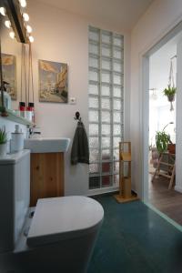 a bathroom with a toilet and a sink at Budapest Skyline Apartment in Budapest