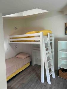 a room with two bunk beds and a bed at Maison de village, centre historique in Sérignan +5 photos