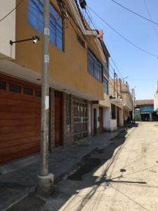 an empty street next to a building at Munay in Tacna