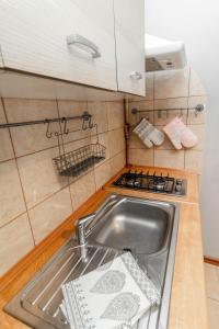 a kitchen with a sink and a stove at Dietla cozy place to stay in Krakow