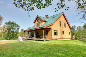 a large wooden house with a green roof on a field at Chester Home with Views about 10 Mi to Okemo Mtn Resort! in Chester