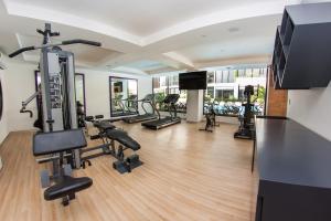 a gym with treadmills and cardio equipment in a building at The City Condos by Menesse in Playa del Carmen