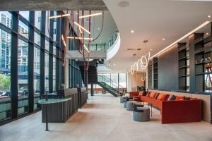 a lobby of a building with couches and a staircase at Cambria Hotel Austin Downtown in Austin