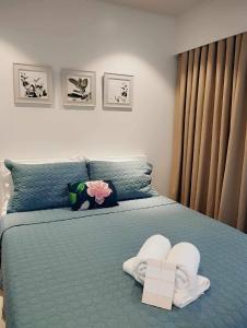 Un dormitorio con una cama azul con toallas. en Lovely Room en Maribago