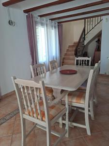 a dining table and chairs in a room with stairs at Casa Olga. This is your holiday Rest with pleasure in Benissa