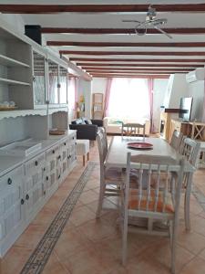 a kitchen and living room with a table and chairs at Casa Olga. This is your holiday Rest with pleasure in Benissa