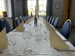 a long table with wine glasses on top of it at Berghotel Sülbeck in Nienstädt