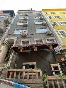 een hoog gebouw met ramen en potplanten erop bij Amür hotel 8 in Istanbul