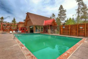 a swimming pool in front of a house at Los Pinos - Luxury Breckenridge SkiCondo in Breckenridge