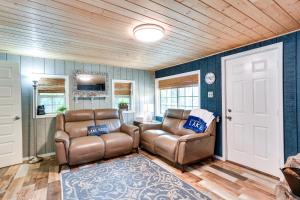 a living room with two chairs and a couch at Kingston Cabin Rental Walk to Lake Texoma Beaches in Shay