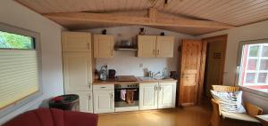 a kitchen with white cabinets and a stove at Bungalow 54 N 11,45 E in Insel Poel