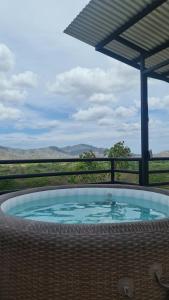 a hot tub with a view of a field at Glamping en Playa Potrero in Potrero