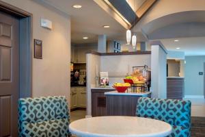 a kitchen with a round table and two chairs at Residence Inn Long Island Hauppauge/Islandia in Hauppauge