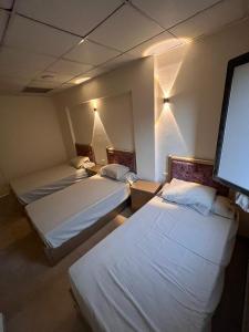Zimmer mit 2 Betten und einem Flachbild-TV in der Unterkunft El jawhra house in Kairo