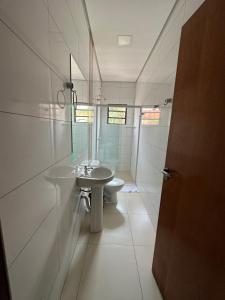 a bathroom with a sink and a toilet at Shafira Hotel in Limeira