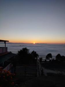 a view of the sunset from the top of a mountain at The Heavens in Almora