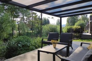 a patio with two chairs and a table on a deck at Tiny House 14 - Sollberg in Salzhemmendorf