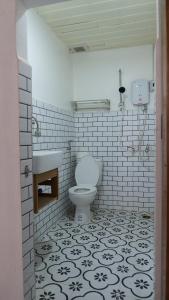 a bathroom with a toilet and a sink at La Casa De Jardin in Luang Prabang