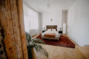 a bedroom with a bed and a large window at Space Age Residence in Łódź