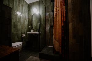 a bathroom with a shower with a toilet and a sink at Space Age Residence in Łódź