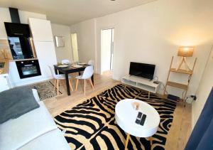a living room with a zebra patterned rug at A l'Université - Poitiers - La Conciergerie. in Poitiers