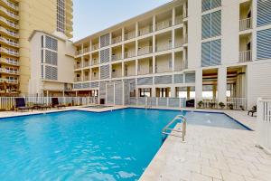 a swimming pool in front of a building at Sea Glass 208 in Gulf Shores