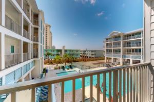 a view of the pool from the balcony of a resort at Sea Glass 208 in Gulf Shores