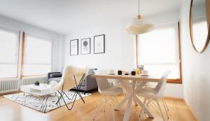 a white dining room with a table and chairs at Orhitxikina in Ochagavía