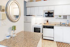 a kitchen with white cabinets and a counter top at Condo 416 at North Creek Resort in Blue Mountains