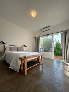 a bedroom with a large bed and a table at Hostel Casa Esterito in La Paz