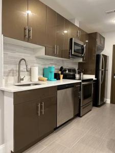 a kitchen with a sink and a microwave at 306 Deluxe double Queen suite in the center city in Philadelphia