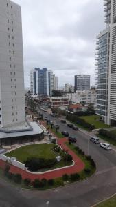 a street in a city with buildings and cars at Torre del Plata II in Punta del Este