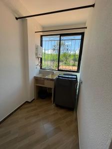 a small bathroom with a sink and a window at Moderno apto familiar piso 2 in Santa Rosa de Cabal