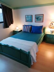 a bedroom with a bed and two night stands at Varandas Miramar in Angra do Heroísmo