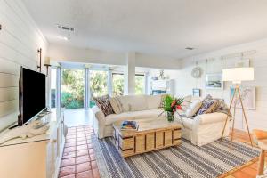 a living room with a couch and a tv at 1207 Lagoon Villas in Amelia Island