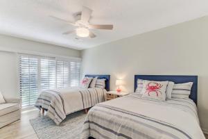 a bedroom with two beds and a ceiling fan at 1207 Lagoon Villas in Amelia Island