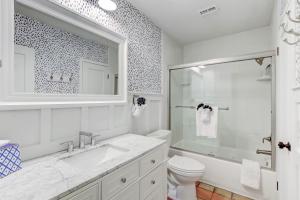 a white bathroom with a sink and a toilet at 1207 Lagoon Villas in Amelia Island