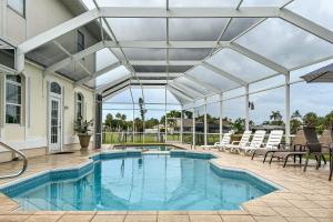 an indoor pool with a retractable roof at Villa Euphoria in Cape Coral