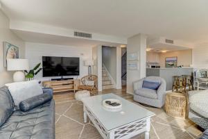 a living room with a couch and a tv at 1132 Beach Walker in Amelia Island