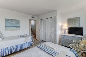 a bedroom with a bed and a flat screen tv at 1132 Beach Walker in Amelia Island +52 photos