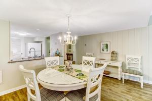 a kitchen and dining room with a table and chairs at 2060 Beach Wood in Amelia Island