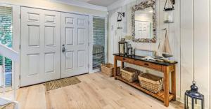 a room with a white door and a table and a mirror at 2129 Beach Wood in Amelia Island