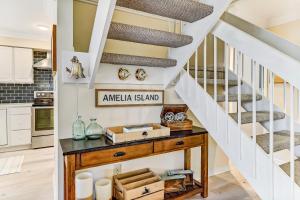 a staircase in a kitchen with a table under a stair case at 2129 Beach Wood in Amelia Island