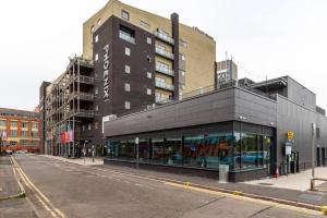 a building on the side of a city street at Stunning Brand New One Bed City Apartment in Leicester