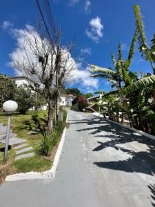 a street with a tree on the side of the road at Residencial Mansur - Jurerê in Florianópolis