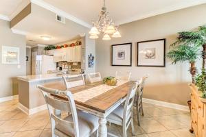 a dining room and kitchen with a wooden table and chairs at 52 Ocean Place in Amelia Island