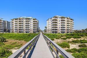 a bridge over a beach with two tall buildings at 52 Ocean Place in Amelia Island