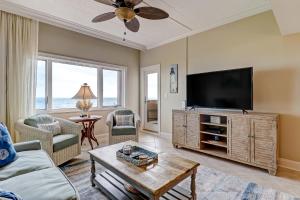 a living room with a flat screen tv and a couch at 291 Sandcastles in Amelia Island